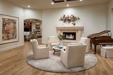 Living room - transitional formal and open concept light wood floor and white floor living room idea in Orange County with a standard fireplace and a stone fireplace