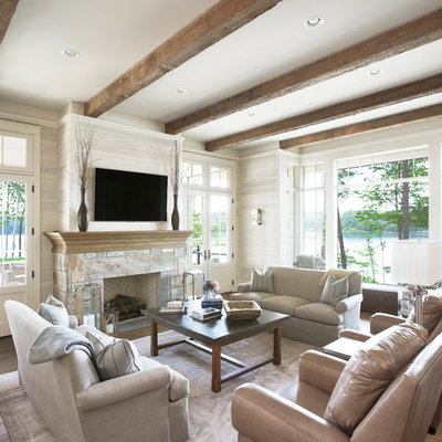 Inspiration for a timeless formal and open concept medium tone wood floor living room remodel in Other with beige walls, a standard fireplace, a stone fireplace and a wall-mounted tv