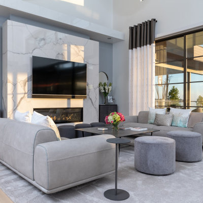 Living room - contemporary open concept light wood floor and beige floor living room idea in Dallas with white walls, a ribbon fireplace, a stone fireplace and a wall-mounted tv