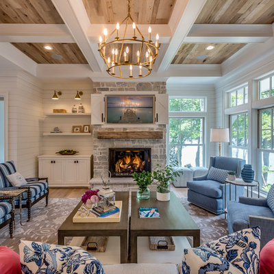 Inspiration for a coastal formal light wood floor living room remodel in Minneapolis with white walls, a standard fireplace, a stone fireplace and a concealed tv