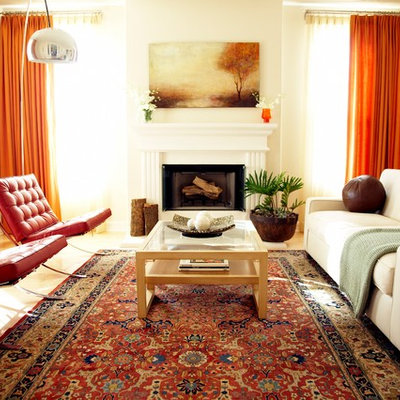 Example of a trendy living room design in Los Angeles with beige walls, a standard fireplace and no tv
