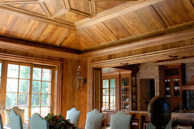 Example of a large classic medium tone wood floor living room design in Other with brown walls, a standard fireplace and a stone fireplace