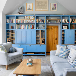 This is an example of a classic living room in Other with white walls, a concealed tv, grey floors and a vaulted ceiling.