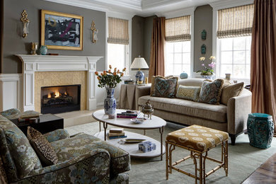 Inspiration for a mid-sized timeless formal and open concept medium tone wood floor and brown floor living room remodel in Chicago with gray walls, a standard fireplace and a tile fireplace
