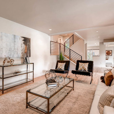Living room - contemporary open concept medium tone wood floor living room idea in Denver with beige walls, no fireplace and no tv