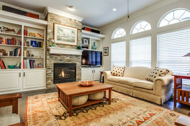Elegant formal living room photo in Dallas with gray walls, a standard fireplace, a stone fireplace and a tv stand