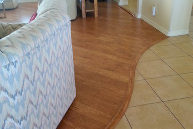 Trendy formal and open concept medium tone wood floor living room photo in Phoenix with beige walls