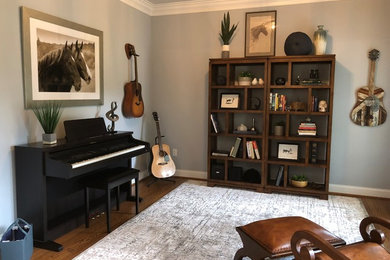Large transitional enclosed medium tone wood floor and brown floor living room photo in Baltimore with a music area, blue walls, no fireplace and no tv