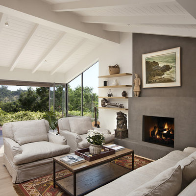 Inspiration for a mid-sized contemporary open concept light wood floor living room remodel in Santa Barbara with a standard fireplace, no tv, a plaster fireplace and white walls