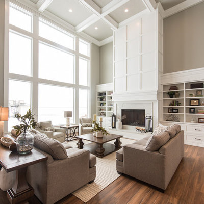 Example of a transitional open concept medium tone wood floor and brown floor living room design in Salt Lake City with beige walls, a standard fireplace and a wood fireplace surround
