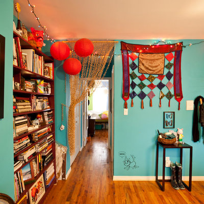 Living room - eclectic medium tone wood floor living room idea in New York with blue walls