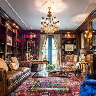 Mittelgroße, Abgetrennte Klassische Bibliothek mit brauner Wandfarbe, Teppichboden, Kamin, Kaminumrandung aus Holz, buntem Boden und verstecktem TV in New York