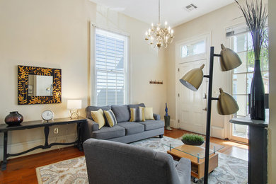 This is an example of a medium sized traditional open plan living room in New Orleans.