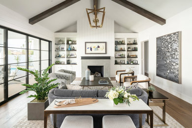 Living room - coastal formal medium tone wood floor living room idea in Phoenix with white walls, a standard fireplace, a concrete fireplace and no tv