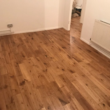 Laying solid oak flooring throughout the flat