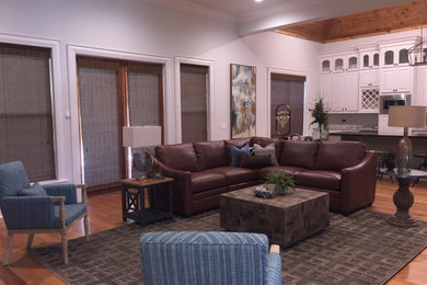 Large transitional open concept medium tone wood floor living room photo with white walls