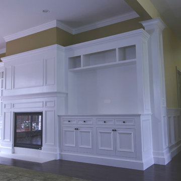 left and right banks of cabinets with fireplace surround