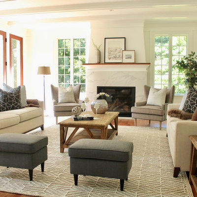 Inspiration for a large transitional open concept medium tone wood floor and brown floor living room remodel in Boston with white walls, a standard fireplace, a stone fireplace and no tv