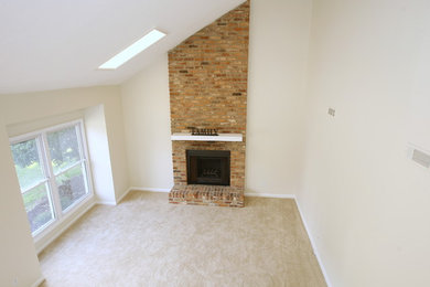 Living room - traditional loft-style carpeted living room idea in Other with a standard fireplace and a brick fireplace