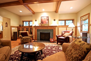 Photo of a medium sized classic formal open plan living room in Detroit with beige walls, light hardwood flooring, a standard fireplace, a brick fireplace surround, no tv and brown floors.