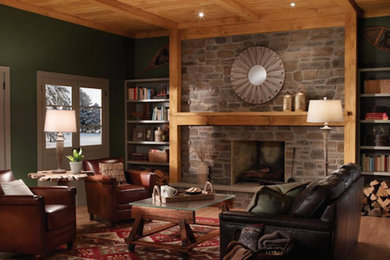 Ejemplo de salón cerrado de tamaño medio con paredes verdes, suelo de madera en tonos medios, todas las chimeneas y marco de chimenea de piedra