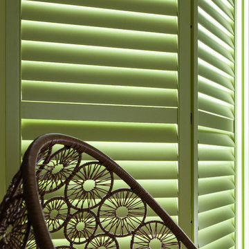 Lime Green Window Shutters with Rattan Chair