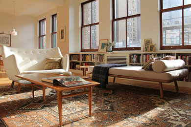 Inspiration for a small eclectic loft-style light wood floor living room remodel in New York with white walls