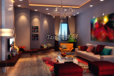 Immagine di un grande soggiorno moderno stile loft con pareti grigie, pavimento in legno massello medio, nessun camino e TV a parete