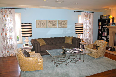 Example of a large trendy enclosed dark wood floor living room design in Los Angeles with blue walls and a tv stand