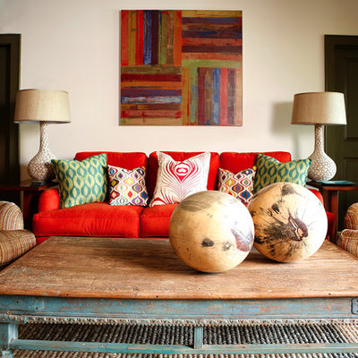 Inspiration for a large transitional enclosed medium tone wood floor living room remodel in Los Angeles with beige walls and no fireplace