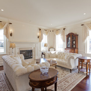 Example of a classic formal living room design in Philadelphia with beige walls and a standard fireplace