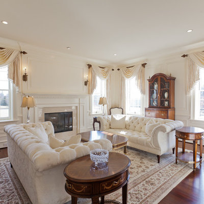 Example of a classic formal living room design in Philadelphia with beige walls and a standard fireplace