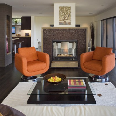 Example of a trendy brown floor living room design in San Francisco with a tile fireplace