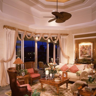 Huge island style living room photo in Miami with beige walls
