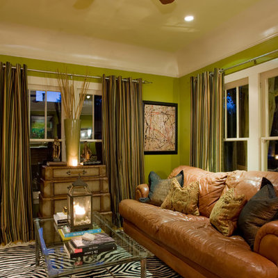 Example of an eclectic enclosed living room design in Phoenix with green walls