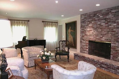 Inspiration for a mid-sized eclectic formal and enclosed light wood floor living room remodel in Manchester with yellow walls, a standard fireplace, a brick fireplace and no tv