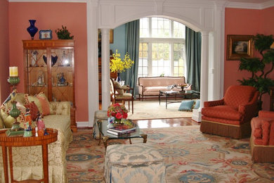 Large elegant formal and enclosed light wood floor living room photo in DC Metro with pink walls