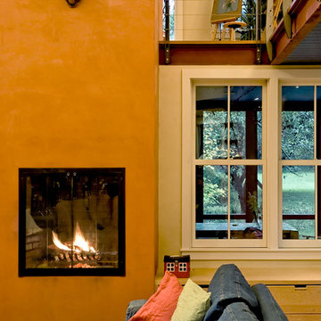 Living room detail at fireplace, window seat and screen porch beyond