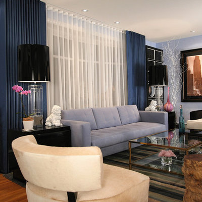 Living room - eclectic medium tone wood floor living room idea in Charleston with blue walls
