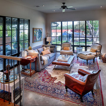 Living Room featuring great windows, steel clad fireplace, concrete floor
