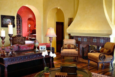 Huge tuscan formal and open concept dark wood floor living room photo in Phoenix with yellow walls, a ribbon fireplace and a plaster fireplace