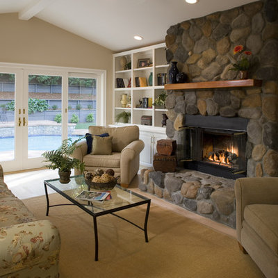 Living room - traditional living room idea in San Francisco with a standard fireplace and a stone fireplace