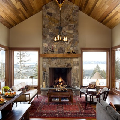 Mountain style living room photo in Boise with a stone fireplace