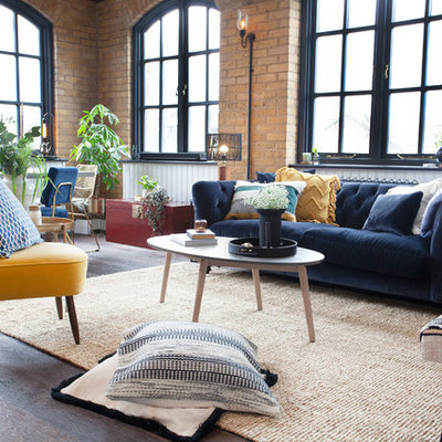 Inspiration for a small industrial open concept dark wood floor and brown floor living room remodel in London