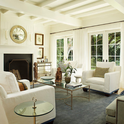 Mid-sized trendy formal and enclosed ceramic tile and brown floor living room photo in Miami with white walls, a standard fireplace, a wood fireplace surround and no tv