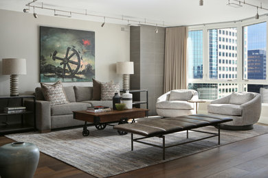 Example of a mid-sized trendy formal and open concept medium tone wood floor and brown floor living room design in Denver with beige walls, no fireplace and no tv