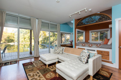 Foto di un soggiorno scandinavo di medie dimensioni e aperto con pareti blu, pavimento in legno massello medio e pavimento marrone