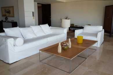 Ejemplo de salón para visitas abierto de tamaño medio con paredes beige, suelo de piedra caliza y suelo beige