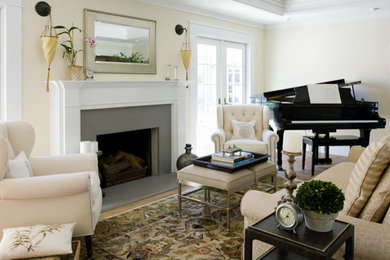Example of a mid-sized classic enclosed light wood floor living room design in New York with yellow walls, a standard fireplace, a plaster fireplace and no tv