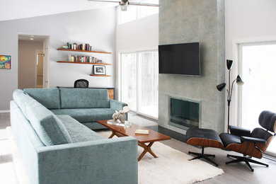 Mid-sized trendy open concept light wood floor and gray floor living room photo in New York with gray walls, a standard fireplace, a tile fireplace and a wall-mounted tv
